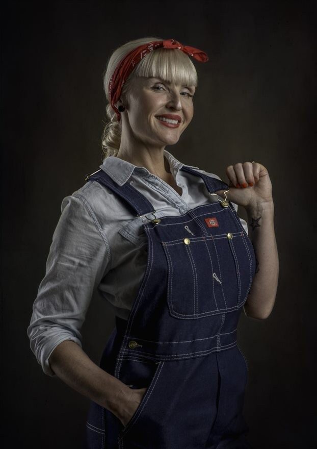 Eva, the owner of Smith Plumbing, Heating, Cooling & Electrical, in a Rosie-the-Riveter-inspired studio portrait
